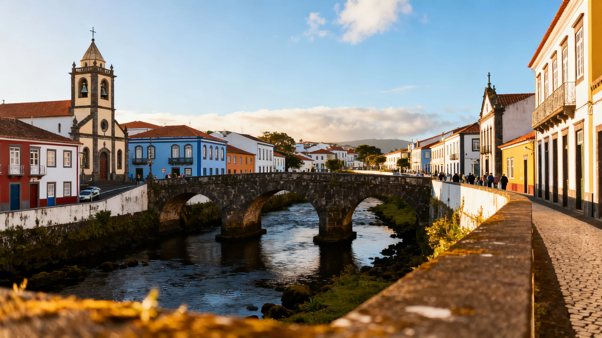 Ribeira Grande historic centre with colorful Portuguese buildings and the stone river bridge